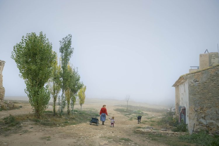 Yannieck Schoonhoven, the co-founder of the Regeneration Academy, her daughter Elena, and Taiga, the dog, walk towards their home in La Junquera farm. She came to work just a few weeks in 2016 and she decided to stay.