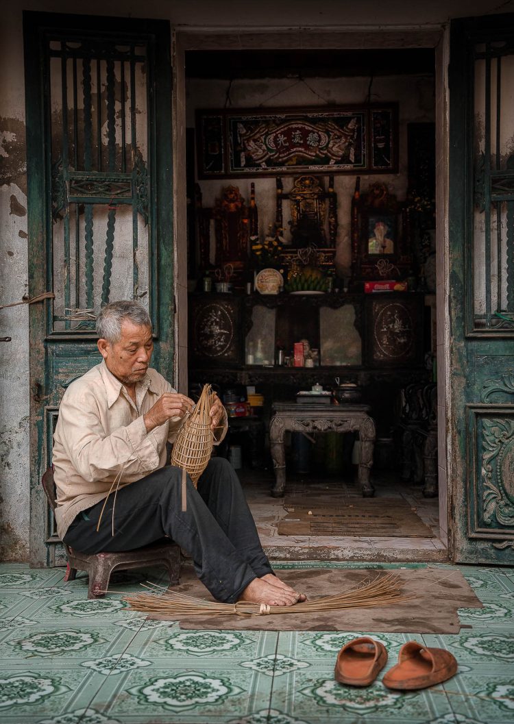 Shrine and Craft
Man weaving a fishing basket at his home shrine