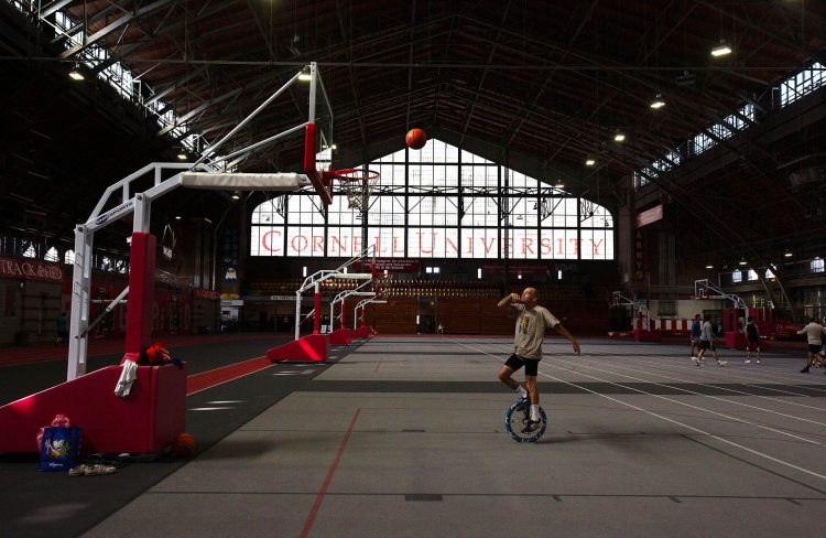 Jean-Guy Beaudry, a retired juggler, plays basketball on a unicycle at Cornell’s yearly Juggling festival on September 21, 2024.