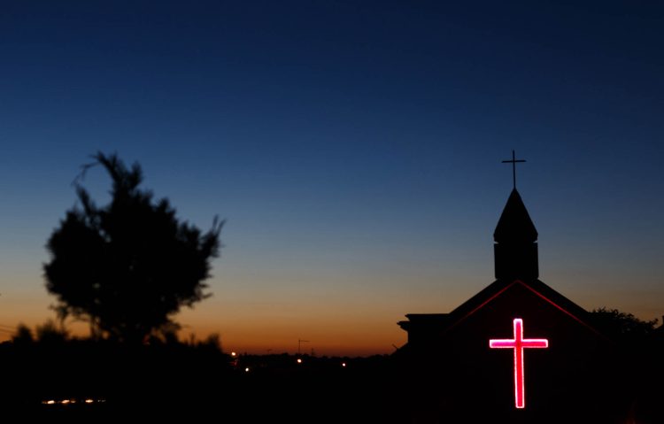 View of the chapel at dusk, where – while the main church building is still under construction – all ceremonies take place.